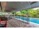 Covered patio provides shade and comfort, perfect for outdoor dining or lounging by the pool at 10609 Orange Grove Dr, Tampa, FL 33618