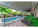Well-lit patio with string lights sets a cozy ambiance for evening gatherings by the pool at 10609 Orange Grove Dr, Tampa, FL 33618