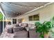 Spacious outdoor patio with ample seating and string lights for entertainment, next to a lush garden at 10609 Orange Grove Dr, Tampa, FL 33618