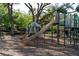 Community playground featuring a slide, swings, climbing structures, and soft ground covering for safety at 10609 Orange Grove Dr, Tampa, FL 33618