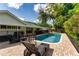 A fenced-in backyard pool ensures a safe swimming environment for your Gathering and friends at 10609 Orange Grove Dr, Tampa, FL 33618
