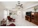 Bright, open living area featuring tile floors, a ceiling fan, and a view into the adjacent kitchen and dining areas at 11841 Whisper Creek Dr, Riverview, FL 33569
