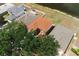 Aerial view of a property with a backyard near a pond, surrounded by mature trees at 13420 Copper Head Dr, Riverview, FL 33569