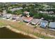 Aerial view of a home with a well-maintained lawn and water views at 13420 Copper Head Dr, Riverview, FL 33569