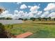 Lush backyard overlooking a pond with a charming brick pathway at 13420 Copper Head Dr, Riverview, FL 33569
