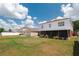 Spacious backyard featuring well-maintained lawn and charming exterior of the home at 13420 Copper Head Dr, Riverview, FL 33569