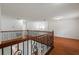 Upstairs loft shows wrought iron railing, and gleaming hardwood floors at 13420 Copper Head Dr, Riverview, FL 33569
