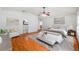 Staged primary suite with hardwood floors, sitting area, and a glimpse into ensuite bathroom at 13420 Copper Head Dr, Riverview, FL 33569