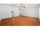 Spacious primary bedroom features hardwood floors, white walls, and ensuite bathroom entrance at 13420 Copper Head Dr, Riverview, FL 33569