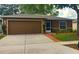 Charming single-story home with a two-car garage and well-maintained front yard landscaping at 13622 Tramore Dr, Odessa, FL 33556