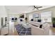 Open-concept living room with hardwood floors, a ceiling fan, and lots of natural light at 13622 Tramore Dr, Odessa, FL 33556