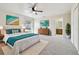 Bright main bedroom featuring a ceiling fan, neutral tones, and ensuite bathroom access at 13622 Tramore Dr, Odessa, FL 33556