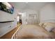 Bright bedroom featuring a modern TV, white metal bed frame, and neutral decor at 15029 Deer Meadow Dr, Lutz, FL 33559
