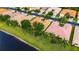 Single-story home has a clay tile roof and meticulously landscaped front yard at 16261 Amethyst Key Dr, Wimauma, FL 33598