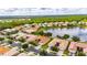An aerial view of a community featuring homes near a calm lake and wooded areas at 16261 Amethyst Key Dr, Wimauma, FL 33598