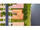 An aerial view showcasing a home with a well-maintained tile roof, landscaping, and lake access in a residential neighborhood at 16261 Amethyst Key Dr, Wimauma, FL 33598