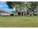 Spacious backyard with a manicured lawn, lake views, and a comfortable patio for outdoor enjoyment at 16261 Amethyst Key Dr, Wimauma, FL 33598