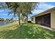 Tranquil backyard with a lovely lake view, mature trees, and a screened-in patio area at 16261 Amethyst Key Dr, Wimauma, FL 33598