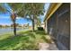 Scenic backyard with well-maintained lawn and direct access to the serene community lake at 16261 Amethyst Key Dr, Wimauma, FL 33598