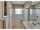 Updated bathroom with a tile shower and glass doors, neutral colors, and an updated vanity and sink at 16261 Amethyst Key Dr, Wimauma, FL 33598