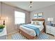 Cozy bedroom with a rattan bed frame, neutral carpet, natural light and simple decor at 16261 Amethyst Key Dr, Wimauma, FL 33598