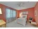 Cozy bedroom with ceiling fan, white furniture, floral curtains, and artwork at 16261 Amethyst Key Dr, Wimauma, FL 33598