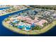 Aerial showcases a stunning resort-style pool with tennis courts and lakeside amenities in the community at 16261 Amethyst Key Dr, Wimauma, FL 33598