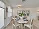 Dining room with a round table, seating for four, and natural light from windows at 16261 Amethyst Key Dr, Wimauma, FL 33598