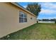 Exterior side view of property featuring the lawn, windows, and waterfront at 16261 Amethyst Key Dr, Wimauma, FL 33598