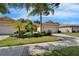 Charming single-story home featuring well-manicured landscaping and a brick driveway at 16261 Amethyst Key Dr, Wimauma, FL 33598