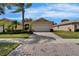 Exterior front of home featuring landscaping, paved driveway, and two-car garage at 16261 Amethyst Key Dr, Wimauma, FL 33598