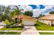 Beautiful single Gathering home featuring a brick driveway, two car garage, and lush tropical landscaping at 16261 Amethyst Key Dr, Wimauma, FL 33598