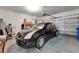 Spacious two-car garage with ample lighting, storage racks, and a clean epoxy floor at 16261 Amethyst Key Dr, Wimauma, FL 33598