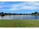 A beautiful expansive lake view behind a well-manicured lawn at 16261 Amethyst Key Dr, Wimauma, FL 33598