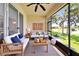 Relaxing screened-in lanai featuring outdoor seating and views of the green lawn at 16261 Amethyst Key Dr, Wimauma, FL 33598