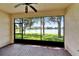 Screened lanai overlooking a pond, with brick floors and neutral paint at 16261 Amethyst Key Dr, Wimauma, FL 33598
