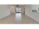 Spacious living area with tile flooring, slider door, and view of community lake at 16261 Amethyst Key Dr, Wimauma, FL 33598