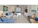 Bright living room featuring water view, comfortable seating, and built-in shelving at 16261 Amethyst Key Dr, Wimauma, FL 33598