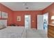 Bright main bedroom with white trim, carpet floors, ceiling fan and access to the ensuite bathroom and hallway at 16261 Amethyst Key Dr, Wimauma, FL 33598