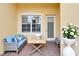 Cozy outdoor patio with a brick floor, window, seating, and decor at 16261 Amethyst Key Dr, Wimauma, FL 33598