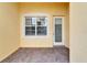 Exterior patio features brick flooring, neutral walls, and a window with blinds at 16261 Amethyst Key Dr, Wimauma, FL 33598