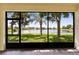 A tranquil view of the community lake from the screened-in lanai offers a peaceful outdoor retreat at 16261 Amethyst Key Dr, Wimauma, FL 33598