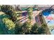 Community shuffleboard courts surrounded by trees, offering a classic recreational activity at 16261 Amethyst Key Dr, Wimauma, FL 33598