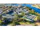 Aerial shot of tennis courts set among lush landscaping and a beautiful lake at 16261 Amethyst Key Dr, Wimauma, FL 33598