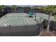 Well-maintained tennis courts with shaded seating area for players and spectators at 16261 Amethyst Key Dr, Wimauma, FL 33598
