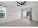 Bedroom with a window and a sliding door leading to the balcony at 1681 Macdonnell Ct, Palm Harbor, FL 34684