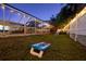 Spacious backyard featuring a cornhole game, perfect for outdoor entertainment and relaxation at 1698 Eden Ct, Clearwater, FL 33756