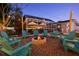 Backyard retreat featuring a fire pit with seating area and a screened-in area for relaxing by the pool at 1698 Eden Ct, Clearwater, FL 33756