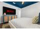 Comfortable bedroom with a large TV and stylish blue accents on the ceiling and cabinet at 1698 Eden Ct, Clearwater, FL 33756