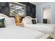 Charming bedroom featuring two beds with a window and stylish palm wallpaper at 1698 Eden Ct, Clearwater, FL 33756